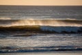 Ocean spray from waves at sundown