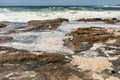 Ocean storm aftermath: A mass of thick foam covered the rocks following extreme storm weather Royalty Free Stock Photo