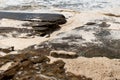 Ocean storm aftermath: A mass of thick foam covered the rocks following extreme storm weather Royalty Free Stock Photo