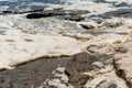 Ocean storm aftermath: A mass of thick foam covered the rocks following extreme storm weather Royalty Free Stock Photo