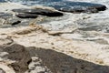 Ocean storm aftermath: A mass of thick foam covered the rocks following extreme storm weather Royalty Free Stock Photo
