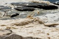 Ocean storm aftermath: A mass of thick foam covered the rocks following extreme storm weather Royalty Free Stock Photo