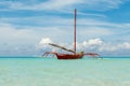 Ocean summer day view with blue sea and sky with white clouds and red boat Royalty Free Stock Photo