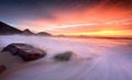 Ocean sunrise as large waves wash onto the beach Royalty Free Stock Photo