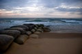 Ocean Sunrise with Sandbags Royalty Free Stock Photo