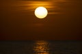 Ocean sunset. Big white sun on dramatic bright sky background, soft evening horizont over sea dark water Royalty Free Stock Photo