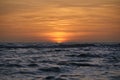 Ocean sunset. Big white sun on dramatic bright sky background, soft evening horizont over sea dark water Royalty Free Stock Photo