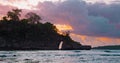 Ocean sunset in Crystal Bay beach in Nusa Penida Bali Indonesia. Sea waves, rock sticking out of water with hole inside. Royalty Free Stock Photo