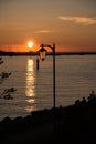 Ocean sunset with a lantern in foregorund Royalty Free Stock Photo