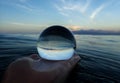 Ocean surface lines and textures with island on horizon captured in ball