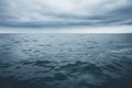 ocean surface under a grey cloud