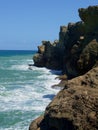 Ocean surging onto coastal rock face