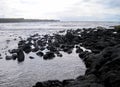 Black lava rock shoreline view Royalty Free Stock Photo