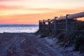 Ocean view of a pathway with a wooden fence