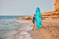 Ocean view and sandy beach. Lady in swimsuit with surfboard. Surf hobby, summer vacation and adventure idea. Copy space Royalty Free Stock Photo