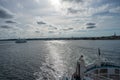 Ocean view towards Elsinore in Denmark from the aft of a boat. Backlit picture with blue ocean and blue sky