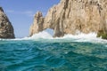 Clear turquoise water waves crash at arch rocks