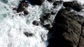 Ocean Water Swirls Amongs Rocks As Seen From Above