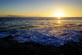 Ocean Water Wave Washing Up on Beach Rocks Sunset Sunshine Royalty Free Stock Photo