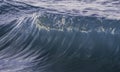 Ocean wave closeup detail of upright crashing hollow breaking water. energy power of nature.