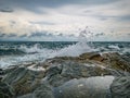 Ocean wave crashing Onto Rocky in the Blue ocean