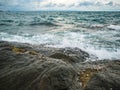 Ocean wave crashing Onto Rocky in the Blue ocean