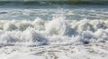 a dynamic ocean scene capturing the raw power and beauty of a wave crashing onto the shore, showcasing the foamy texture and energ Royalty Free Stock Photo