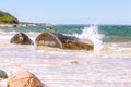 Ocean wave spraying on large rock on Martha`s Vineyard, MA