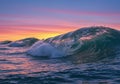 Ocean Wave at Sunset with Vibrant Pink and Purple Sky Royalty Free Stock Photo