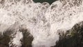 Ocean waves along a rocky coast. Slow motion seascape with epic rocks and waves