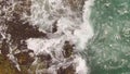 Ocean waves along a rocky coast. Slow motion seascape with epic rocks and waves crashing against the village. Royalty Free Stock Photo