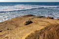 Ocean waves approach a rocky beach near San Diego, California.