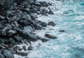 Ocean waves on black pebble stone coast