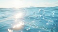 Ocean waves with bubbles at sunrise, tranquil water and sunlight reflection. Nature and serenity concept Royalty Free Stock Photo