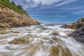 Ocean waves crashing against a rocky shore- slow shutterspeed Royalty Free Stock Photo