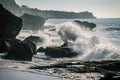 Ocean waves crashing onto the rocks in the sunset