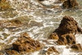 Ocean waves crashing on rocks on coastline at high tide