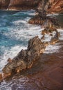 Ocean waves crashing on the rocky island coast. Splashing ocean waves and stones. Red Sand Beach, Maui in in Hawaiian. Royalty Free Stock Photo