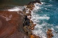 Ocean waves crashing on the rocky island coast. Splashing ocean waves and stones. Red Sand Beach, Maui in in Hawaiian. Royalty Free Stock Photo