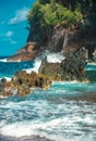 Ocean waves crashing on the rocky island coast. Splashing ocean waves and stones. Red Sand Beach, Maui in in Hawaiian. Royalty Free Stock Photo