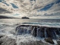 Ocean waves crushing on rough stone coast of rugged Irish coast line with cliffs. Kilkee area, Ireland. Popular travel and tourism Royalty Free Stock Photo