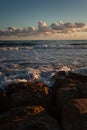 Ocean waves gently kiss sandy shore under twilight sky. Royalty Free Stock Photo