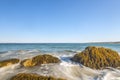 Ocean waves lash line impact rock on the beach