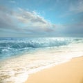 Ocean waves rolling on sandy beach under sky with clouds Royalty Free Stock Photo