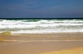 Ocean waves rushing to shore on a sandy beach Royalty Free Stock Photo