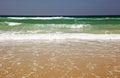 Ocean waves rushing to shore on a sandy beach Royalty Free Stock Photo