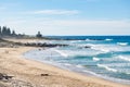 Ocean waves and sandy beach on a sunny day. Nature tropical paradise background. Tuross Head, NSW, Australia