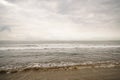 Ocean waves on Santa Monica beach in cloudy november day Royalty Free Stock Photo