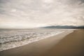 Ocean waves on Santa Monica beach in cloudy november day Royalty Free Stock Photo