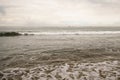 Ocean waves on Santa Monica beach in cloudy november day Royalty Free Stock Photo